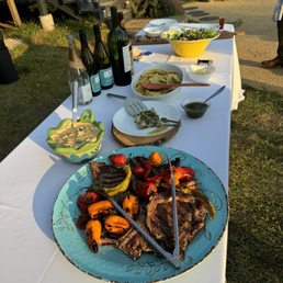 Outdoor dinner spread with wine